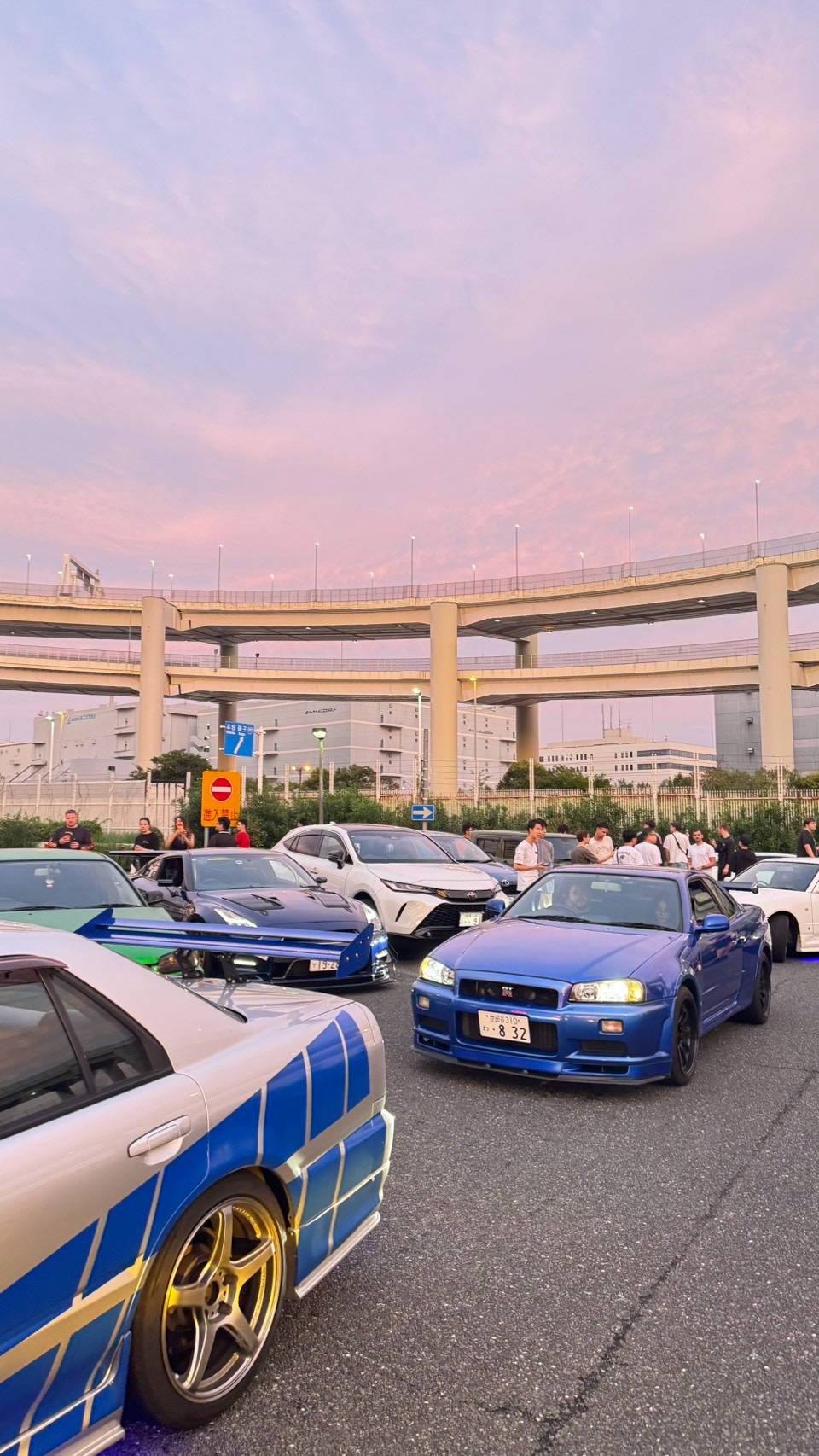 Japanese performance cars gathered at Daikoku at dusk
